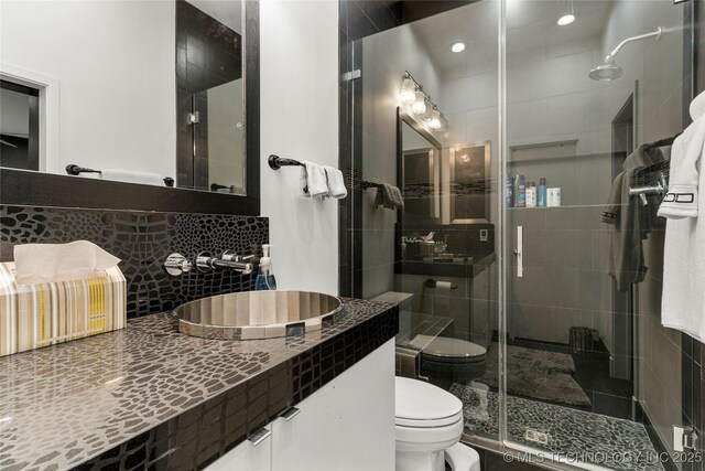 2440 E 47th Pl, Tulsa, OK 74105 - full bathroom with toilet, a stall shower, vanity, and backsplash