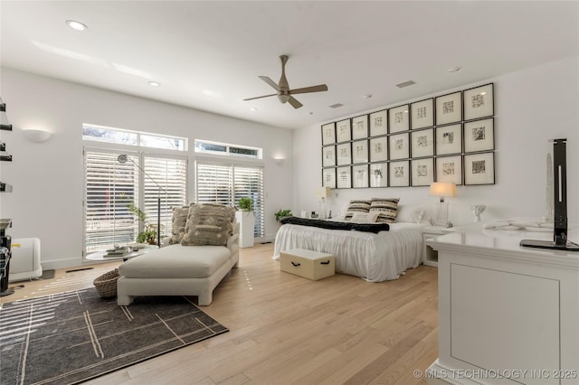 bedroom with a ceiling fan, recessed lighting, light wood-style floors, and visible vents