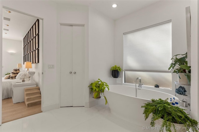 2440 E 47th Pl, Tulsa, OK 74105 - ensuite bathroom featuring a soaking tub and recessed lighting