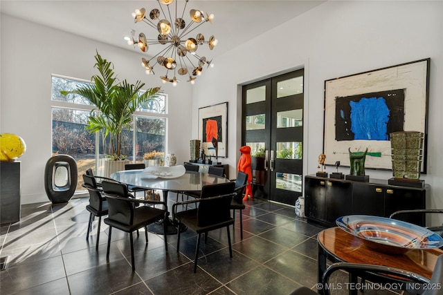 dining space with tile patterned flooring, a notable chandelier, french doors, and baseboards