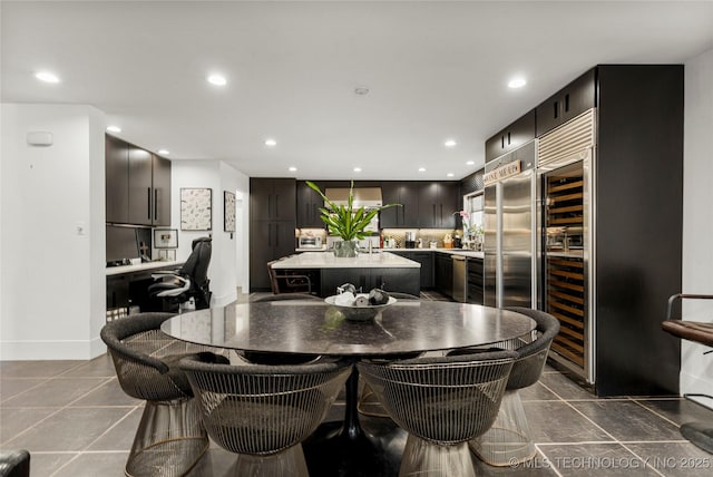 dining space with dark tile patterned floors and recessed lighting