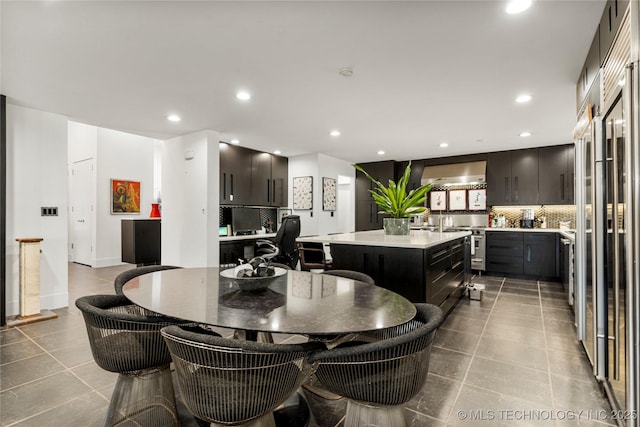 tiled dining area with recessed lighting and baseboards