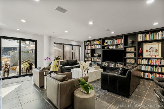 living room with tile patterned floors, visible vents, built in features, and recessed lighting