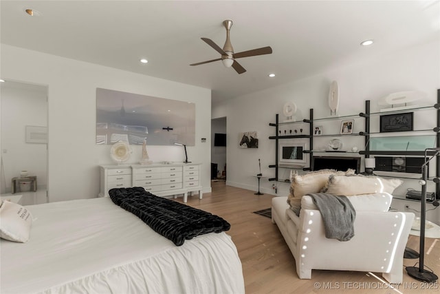 bedroom featuring recessed lighting, baseboards, wood finished floors, and a ceiling fan