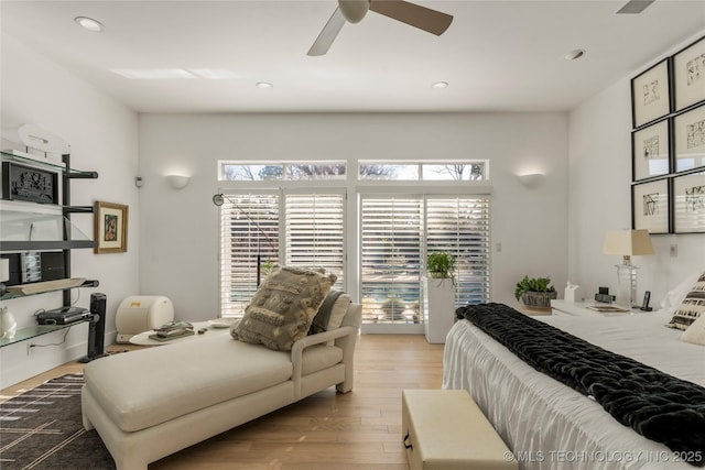 bedroom featuring recessed lighting, multiple windows, wood finished floors, and access to outside