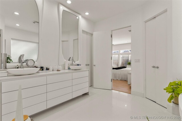 2440 E 47th Pl, Tulsa, OK 74105 - bathroom with ensuite bath, double vanity, and recessed lighting