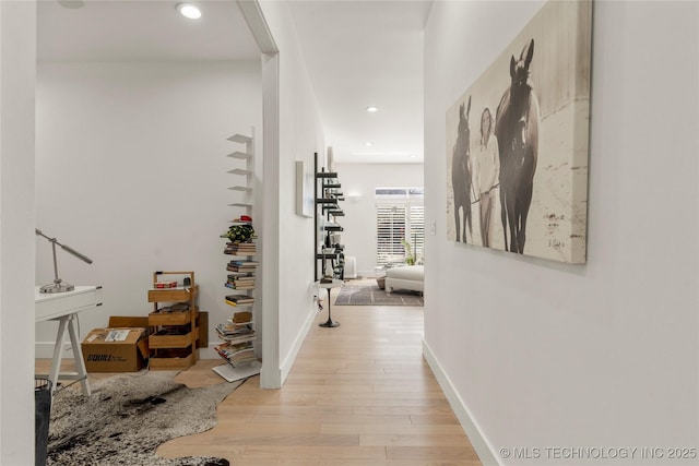 hall with recessed lighting, baseboards, and light wood finished floors