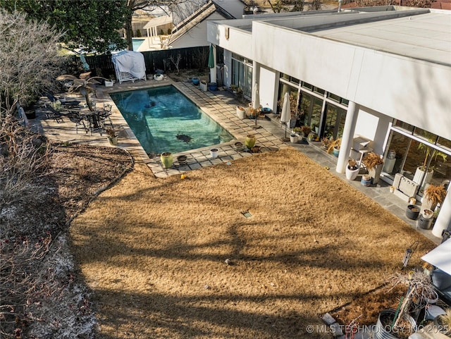 view of pool with fence, a yard, a patio area, and a fenced in pool