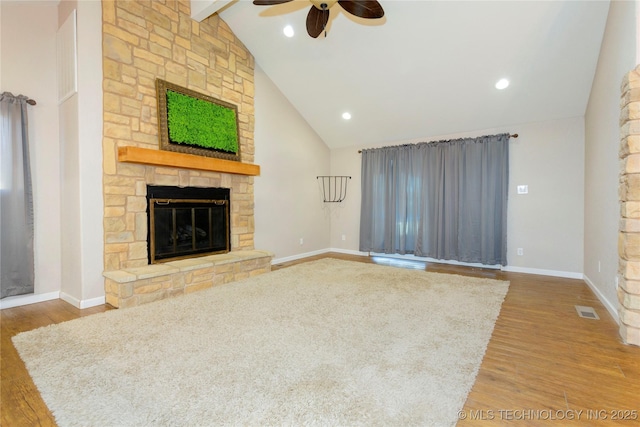 unfurnished living room featuring visible vents, a fireplace, baseboards, and wood finished floors