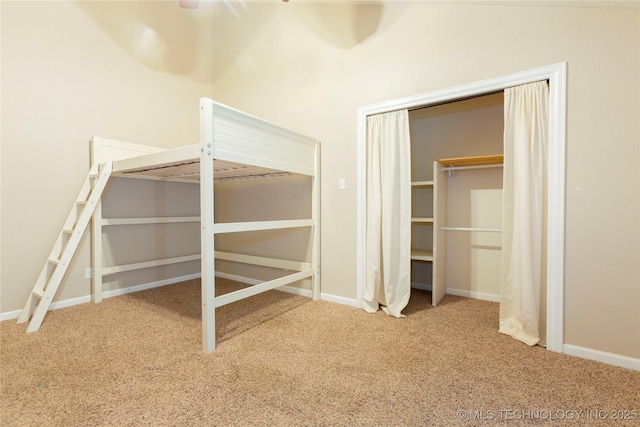 unfurnished bedroom featuring a closet, carpet flooring, and baseboards