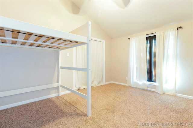 basement featuring baseboards and carpet floors