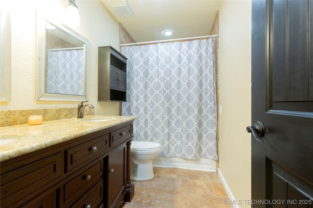 bathroom featuring double vanity, shower / bath combination with curtain, toilet, and a sink