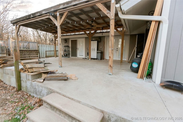 view of patio with a carport and fence