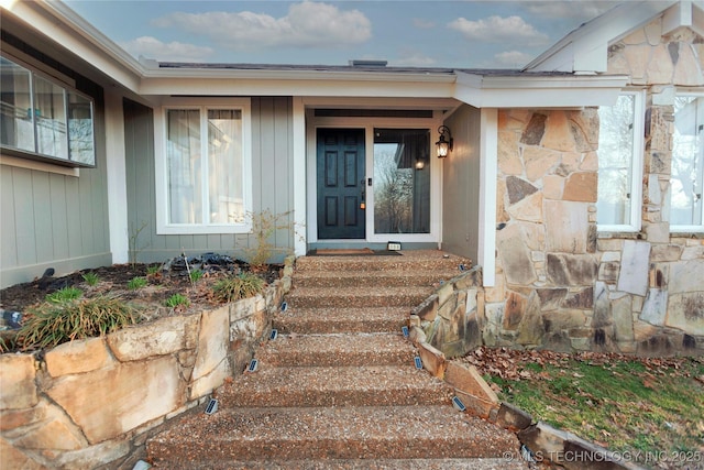 doorway to property featuring stone siding