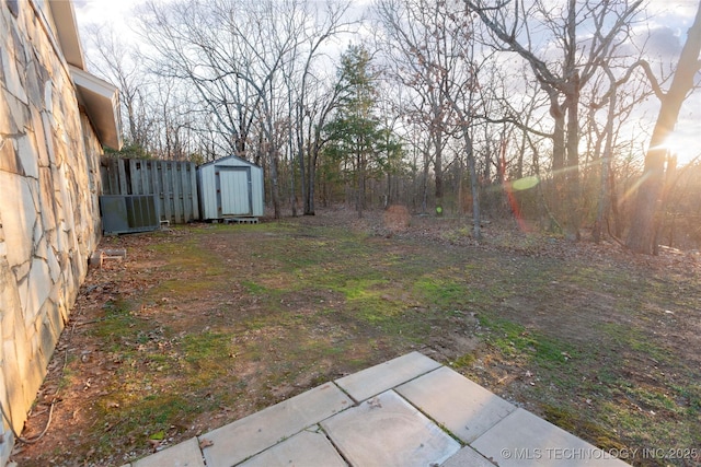 view of yard featuring central air condition unit, fence, an outdoor structure, and a shed