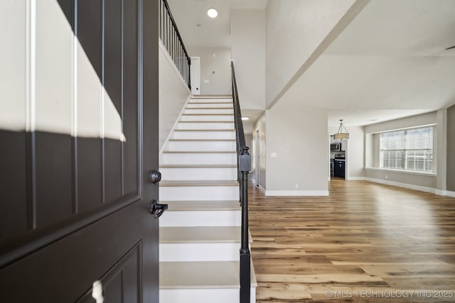 entrance foyer featuring stairs, recessed lighting, wood finished floors, and baseboards