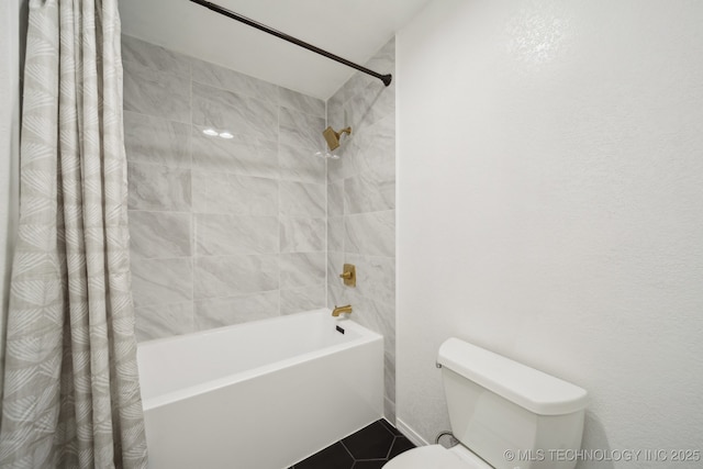 bathroom with tile patterned flooring, shower / tub combo, and toilet