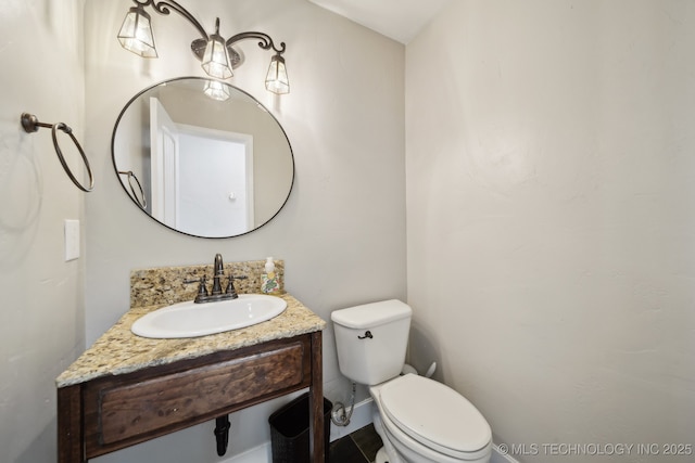 half bathroom with vanity and toilet