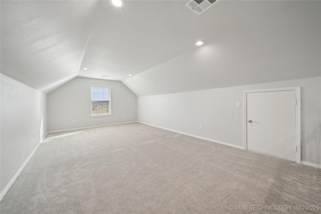 bonus room with visible vents, baseboards, carpet flooring, and vaulted ceiling