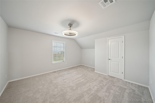 bonus room with visible vents, lofted ceiling, baseboards, and carpet flooring