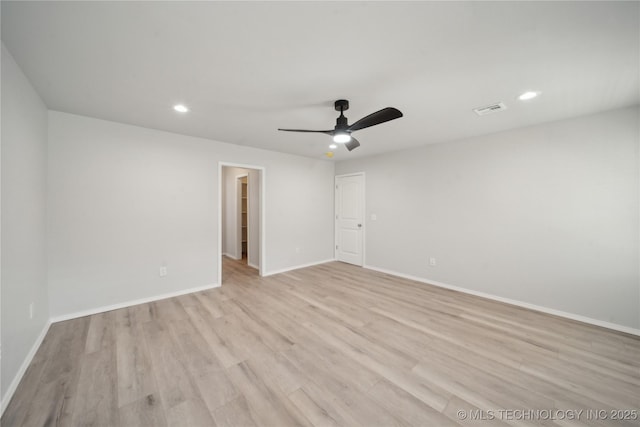 empty room featuring recessed lighting, visible vents, light wood-type flooring, and baseboards