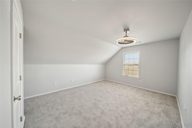 additional living space featuring lofted ceiling, carpet, visible vents, and baseboards