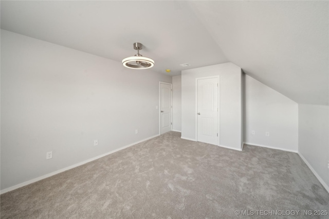 bonus room with baseboards, carpet floors, and lofted ceiling