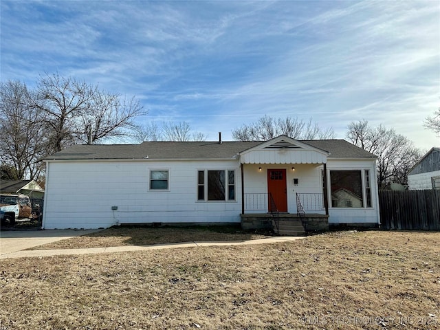 single story home featuring fence