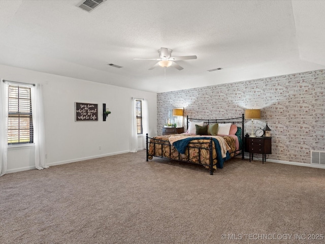 bedroom with visible vents, a textured ceiling, and carpet floors