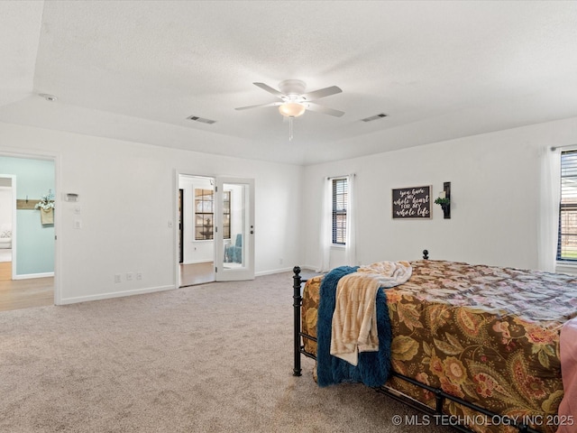 carpeted bedroom with visible vents, ceiling fan, a textured ceiling, and baseboards