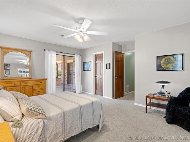 carpeted bedroom with access to exterior, visible vents, baseboards, a textured ceiling, and a ceiling fan