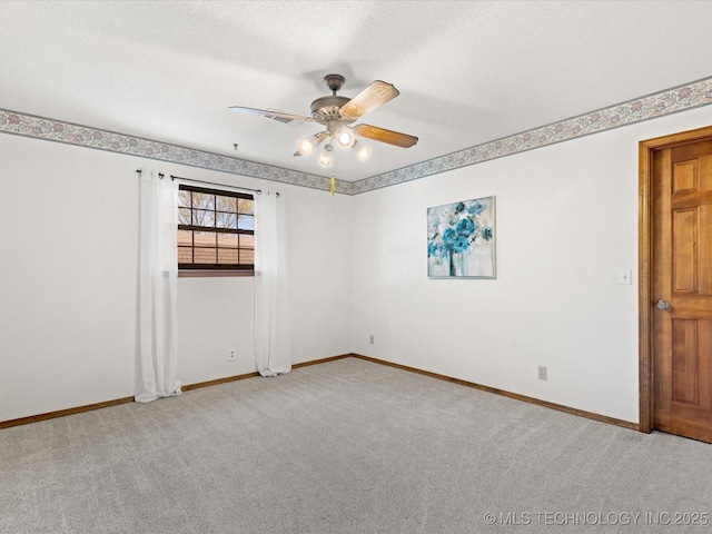 unfurnished room featuring a ceiling fan, baseboards, carpet floors, and a textured ceiling