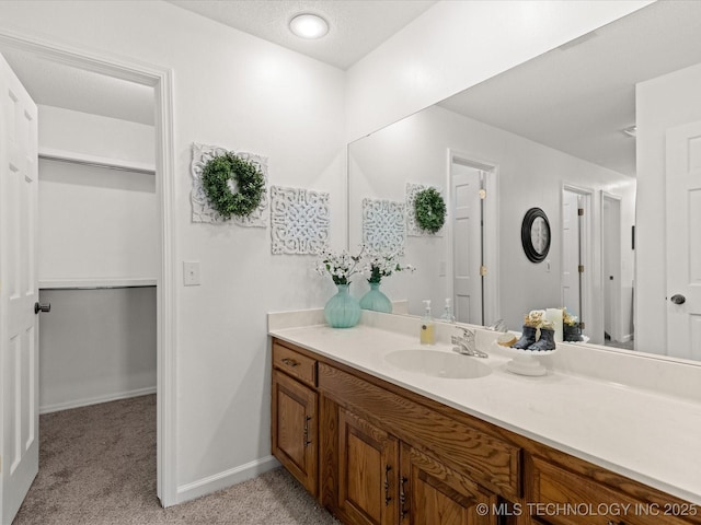 bathroom featuring vanity and baseboards