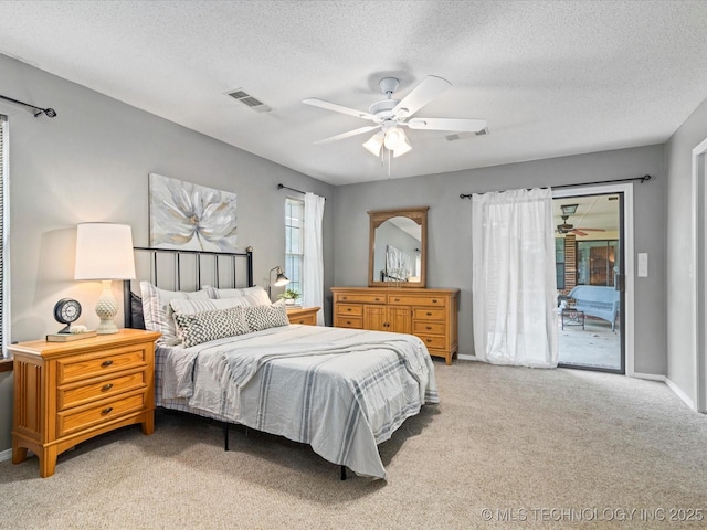 2540 Chapel Hill Rd, Bartlesville, OK 74006 - bedroom featuring access to exterior, light colored carpet, a textured ceiling, a ceiling fan, and baseboards