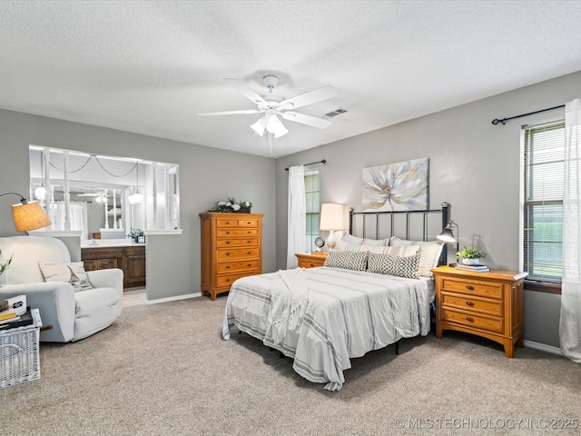 carpeted bedroom featuring baseboards, a ceiling fan, a textured ceiling, and visible vents