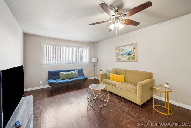 living room with baseboards, wood finished floors, and a ceiling fan