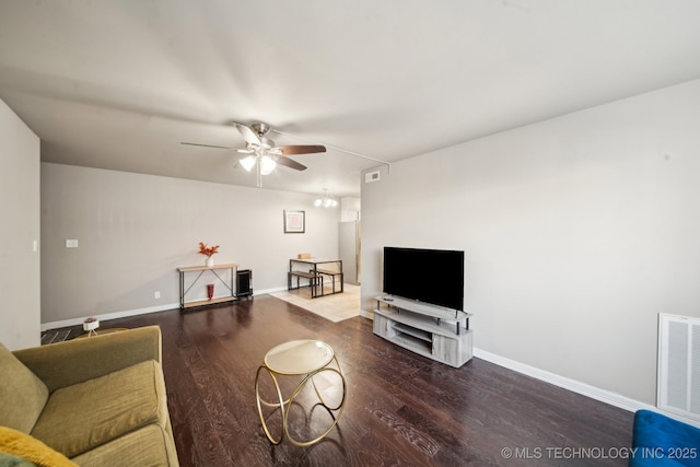 living area featuring visible vents, baseboards, and wood finished floors