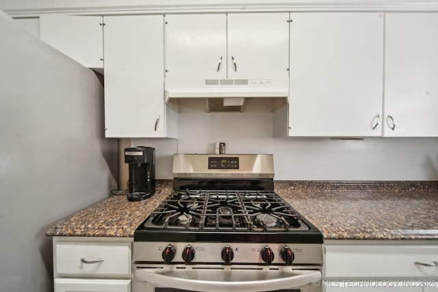 kitchen featuring white cabinetry, under cabinet range hood, and stainless steel range with gas cooktop