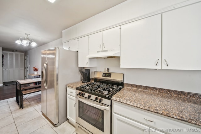 kitchen featuring under cabinet range hood, stainless steel appliances, an inviting chandelier, white cabinets, and light tile patterned floors