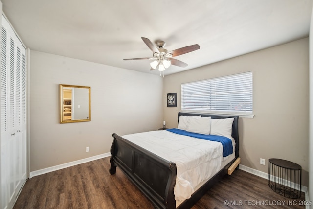 bedroom with a closet, a ceiling fan, baseboards, and wood finished floors