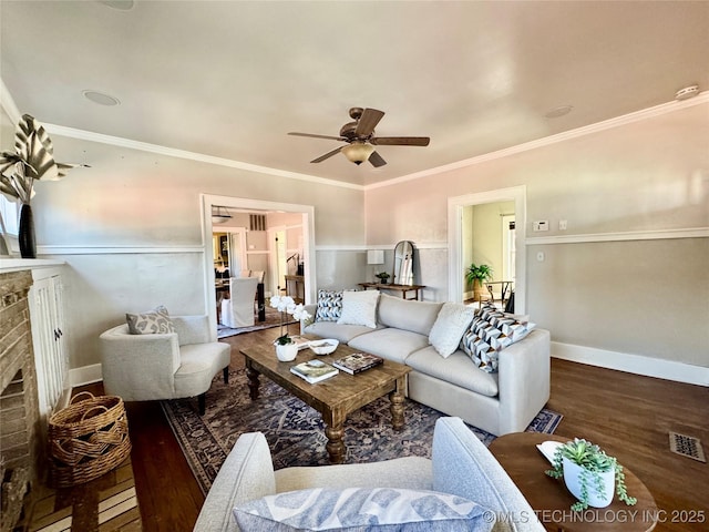 living room featuring a fireplace, wood finished floors, visible vents, and a ceiling fan