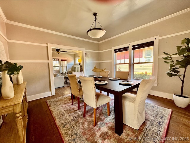 dining room with a ceiling fan, crown molding, baseboards, and hardwood / wood-style floors