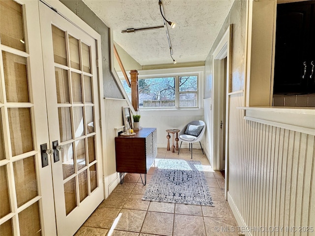 sunroom with french doors and track lighting