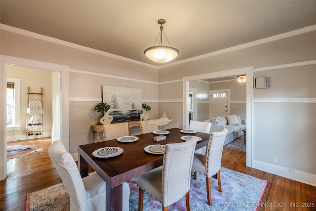 dining room featuring ornamental molding and wood finished floors