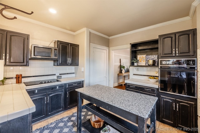 kitchen featuring black appliances, open shelves, backsplash, crown molding, and tile counters