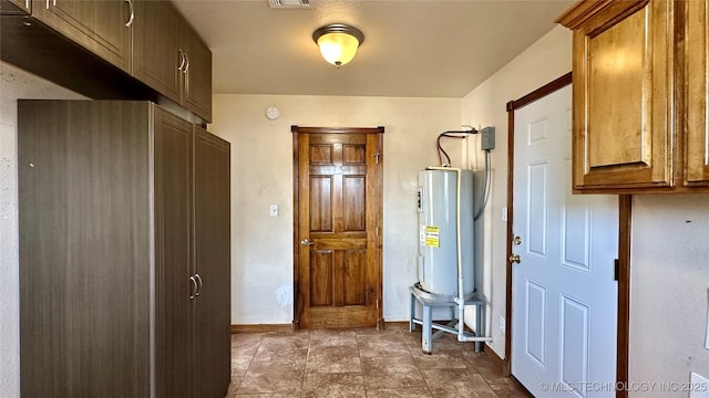 interior space with visible vents and water heater