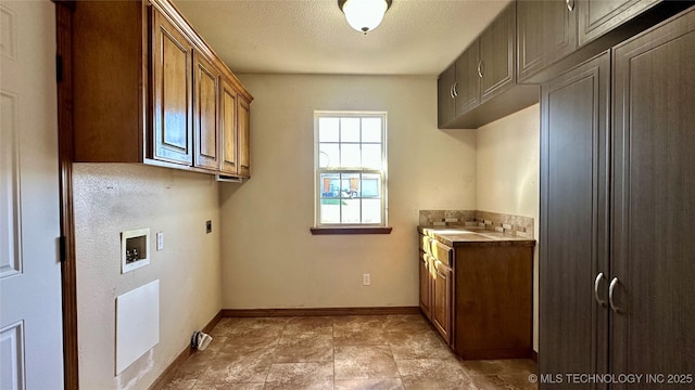 clothes washing area featuring hookup for a washing machine, cabinet space, baseboards, and electric dryer hookup