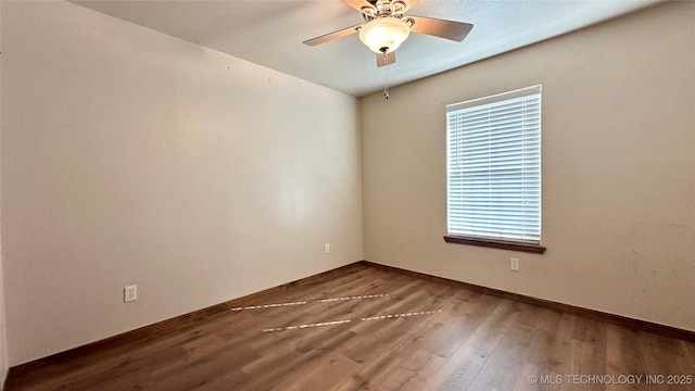 spare room featuring ceiling fan, baseboards, and wood finished floors