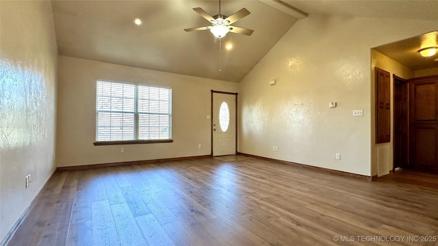 interior space with baseboards, ceiling fan, beam ceiling, wood finished floors, and high vaulted ceiling