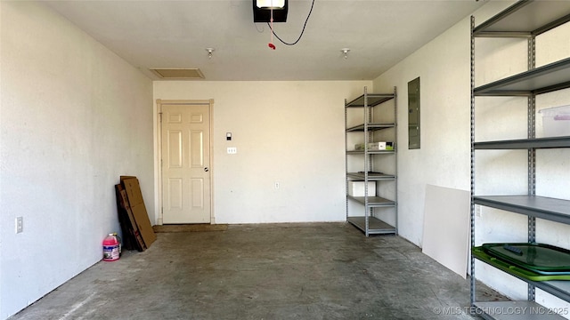 garage with electric panel and a garage door opener